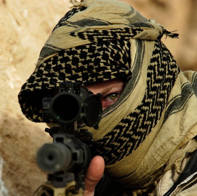 Army Special Forces soldier in a desert scarf aiming a scoped Mk12 rifle toward the camera, Rawah, Iraq, 2007