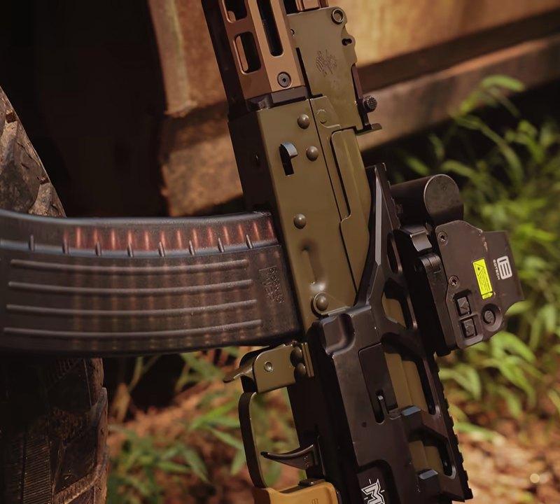 PSA Sabre 5.56 AK leaning on a tire with the WBP 5.56 magazine and ALG trigger visible