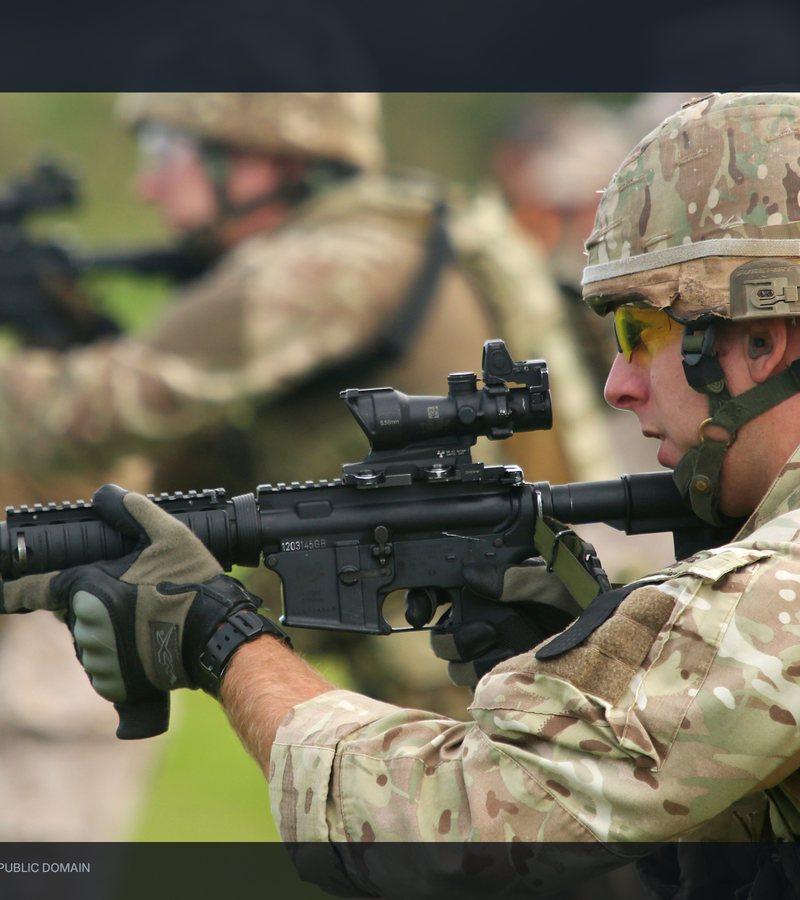 A British Royal Marine firing a Colt Canada C8 carbine during Exercise Tartan Eagle